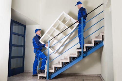 Professional removals team handling furniture in a Maida Vale flat