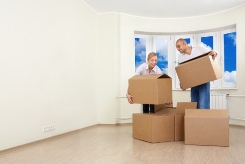 Specialist movers transporting a grand piano through a narrow interior space